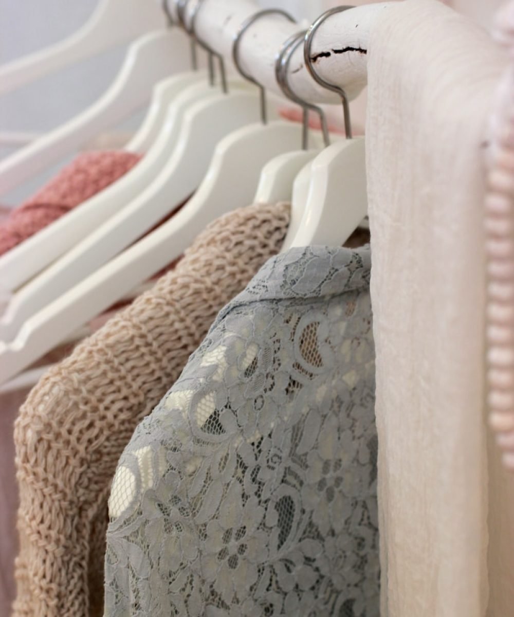 clothes hanging on white rack